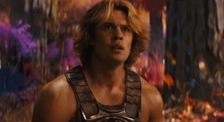 very muscular young man with wave blond hair in a He-Man costume.