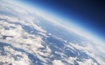 a view of Earth's atmosphere from above, with plenty of scattered clouds.