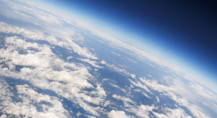 a view of Earth's atmosphere from above, with plenty of scattered clouds.