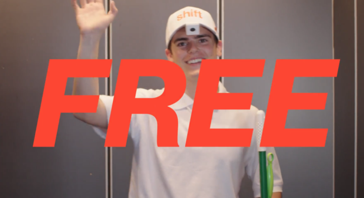 A person wearing a white hat with the word "Shift" and a camera attached to the hat brim is waving and smiling while holding a cleaning mop and Swiffer. The word "Free" in big red letters is in the foreground.