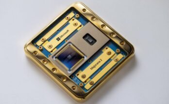 Image of a computer chip and its packaging, mostly with gold metal and green circuitboard.