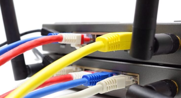 Ethernet cables connected to the ports in a wireless router