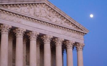 Exterior view of Supreme Court building and its marble columns.