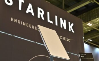 A Starlink terminal in front of a sign that says, "Starlink: Engineered by SpaceX."