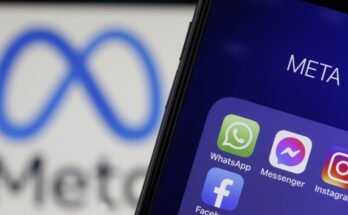 In this photo illustration, the icons of WhatsApp, Messenger, Instagram and Facebook are displayed on an iPhone in front of a Meta logo