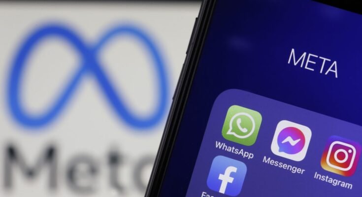 In this photo illustration, the icons of WhatsApp, Messenger, Instagram and Facebook are displayed on an iPhone in front of a Meta logo