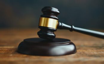 A gavel on a wooden desk