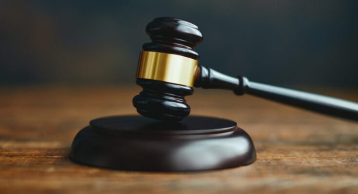 A gavel on a wooden desk